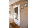 Close-up of the front door featuring the unit number, a welcome mat, and secure entry at 1261 S Gilbert St # 202, Castle Rock, CO 80104