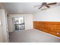 Bright living room with sliding glass doors to balcony, ceiling fan, and wood accents at 1261 S Gilbert St # 202, Castle Rock, CO 80104