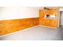 Spacious living area with cozy carpet and wood-paneled accent wall, open to the kitchen at 1261 S Gilbert St # 202, Castle Rock, CO 80104