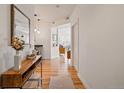 Bright hallway with hardwood floors, connecting the living spaces, offering a glimpse into the home's layout at 2195 Decatur St # 212, Denver, CO 80211
