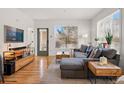 Cozy living room boasts a comfortable sectional sofa and abundant natural light, perfect for relaxation at 2195 Decatur St # 212, Denver, CO 80211