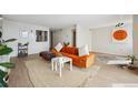 Inviting open-concept living area with stylish decor, with an inviting orange sofa, rug and decor at 1020 15Th St # 35N, Denver, CO 80202