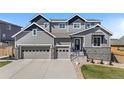 Beautiful two-story home with an attached three-car garage and landscaped front yard at 4009 Manorbrier Cir, Castle Rock, CO 80104