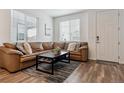 Cozy living room with a comfortable leather sectional, modern rug, and natural light at 18304 Caffey Dr, Parker, CO 80134