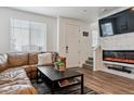 Stylish living room with a modern fireplace, mounted TV, and a comfortable leather sectional at 18304 Caffey Dr, Parker, CO 80134