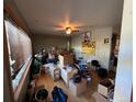 An cluttered living room with large windows, a ceiling fan, and unique decorative items and walls at 841 S 6Th Ave, Brighton, CO 80601