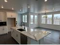 Bright kitchen featuring a large island with modern countertops and stainless steel appliances at 16529 Black Rose Cir, Parker, CO 80134