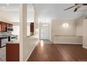 Spacious living room with hardwood floors offering views into the kitchen and entryway at 1249 S Irving St, Denver, CO 80219