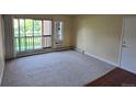 Inviting living room with neutral carpeting and a large window providing natural light at 850 W Moorhead Cir # 3F, Boulder, CO 80305