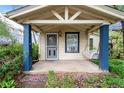 Inviting covered porch with decorative columns and a swing, perfect for relaxing outdoors at 4151 Zenobia St, Denver, CO 80212