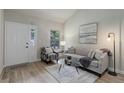 Inviting living room with wood-look floors and decor, filled with natural light and comfortable furnishings at 17605 Ponderosa Ave, Parker, CO 80134