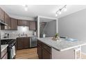 Updated kitchen featuring stainless steel appliances, an island, and wood floors at 8979 Field St # 27, Westminster, CO 80021