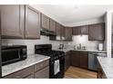 Modern kitchen with stainless steel appliances, wood floors and light countertops at 8979 Field St # 27, Westminster, CO 80021