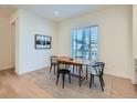 Inviting dining room featuring a wooden table, black chairs, and a large window at 805 Promenade Dr, Superior, CO 80027