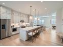 Modern kitchen showcases a large island, light gray cabinetry, and an open-concept design at 805 Promenade Dr, Superior, CO 80027