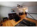 Inviting living room with hardwood floors, ceiling fan, comfortable seating, and an adjacent dining area at 18908 E Napa Dr, Aurora, CO 80013