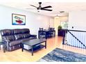 Cozy living room with hardwood floors, a ceiling fan, and comfortable furniture at 18908 E Napa Dr, Aurora, CO 80013