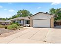 Inviting single-story home with a well-maintained front yard and spacious driveway at 17601 E Eastman Pl, Aurora, CO 80013