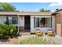 Close-up of the front entrance with blue shutters and a cozy seating area at 17601 E Eastman Pl, Aurora, CO 80013