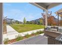 Relaxing front porch overlooking a well-maintained lawn and picturesque neighborhood street at 9768 E 62Nd Dr, Denver, CO 80238