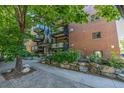 Brick apartment building showcasing well-maintained landscaping and a walkway leading to the entrance at 1245 Columbine St # 306, Denver, CO 80206