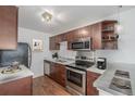 Modern kitchen with stainless steel appliances, sleek countertops, and wooden cabinetry at 1245 Columbine St # 306, Denver, CO 80206