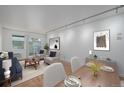 Bright living room featuring hardwood floors, a dining area, and modern furnishings at 1245 Columbine St # 306, Denver, CO 80206
