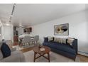 Open-concept living room with hardwood floors, modern furniture, and ample natural light at 1245 Columbine St # 306, Denver, CO 80206