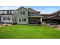 Well-maintained backyard featuring a lush green lawn and covered patio, perfect for outdoor entertaining at 8550 Cheraw St, Littleton, CO 80125