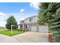 Spacious home with a manicured lawn, featuring a two-car garage and mature landscaping at 11821 Joplin Ct, Commerce City, CO 80022