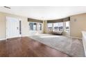 Bright living room featuring hardwood floors, large windows, neutral walls, and ample natural light at 11821 Joplin Ct, Commerce City, CO 80022