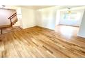Spacious living room featuring hardwood floors and natural light from adjacent rooms at 4753 S Gar Way, Littleton, CO 80123
