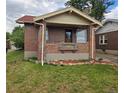 Charming brick home with a cozy front porch and well-maintained landscaping at 2034 S Lincoln St, Denver, CO 80210