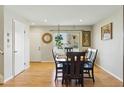 Cozy dining room featuring hardwood floors, and warm natural light from a large window at 4581 S Garrison St, Littleton, CO 80123