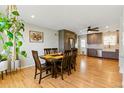 Open concept view of the dining area next to an updated kitchen with modern appliances at 4581 S Garrison St, Littleton, CO 80123