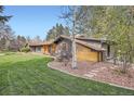 Inviting single-story home showcasing a lush green lawn and charming landscaping, perfect for outdoor enjoyment at 4 Meadowlark Ln, Littleton, CO 80123