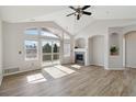 Bright living room with high ceilings, modern ceiling fan, and sliding glass door to the outside at 1574 Olympia Cir # 305, Castle Rock, CO 80104