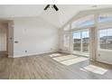Bright living room boasts vaulted ceilings, natural light, and sliding door leading to the deck at 1574 Olympia Cir # 305, Castle Rock, CO 80104