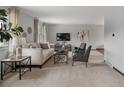 Bright living room featuring neutral paint, plush carpet, and tastefully curated decor at 5292 W Fair Dr, Littleton, CO 80123