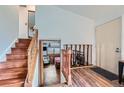 Inviting entryway with wood floors and staircase leading to the upper level at 17232 E Oberlin Pl, Aurora, CO 80013