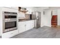 Modern kitchen features stainless steel appliances, sleek countertops, and ample cabinet space at 591 Nome St, Aurora, CO 80010