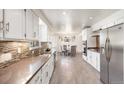 Open-concept kitchen seamlessly flows into the dining area, ideal for entertaining and everyday living at 591 Nome St, Aurora, CO 80010