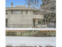 Front view of a two story townhome with snow covered landscaping at 1825 Kendall St # 101, Lakewood, CO 80214