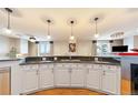 Modern kitchen with pendant lighting, granite countertops, and white cabinets at 1827 N Grant St # 1000, Denver, CO 80203