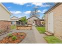 Backyard view showcasing a raised garden bed and a pergola-covered seating area at 3649 N Garfield St, Denver, CO 80205