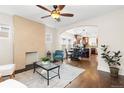 Inviting living room with hardwood floors, decorative fireplace, and open floor plan to dining and kitchen at 3649 N Garfield St, Denver, CO 80205