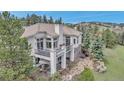 Lovely home with an outdoor patio, a charming balcony, mature trees, and professional landscaping at 730 Summerwood Dr, Golden, CO 80401