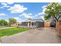 Well-lit exterior showcasing a beautifully renovated home with a spacious driveway and mature landscaping at 3540 E 91St Ave, Thornton, CO 80229