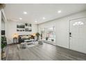 Bright living room with a large window, fresh paint, modern lighting and attractive gray-toned flooring at 3540 E 91St Ave, Thornton, CO 80229