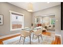 Bright dining room with a modern table set and hardwood floors, seamlessly connecting to the living area at 1532 Meade St, Denver, CO 80204